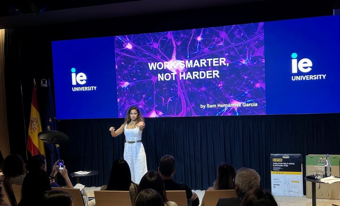 Sam on stage at IE University presenting “Work smarter, not harder”